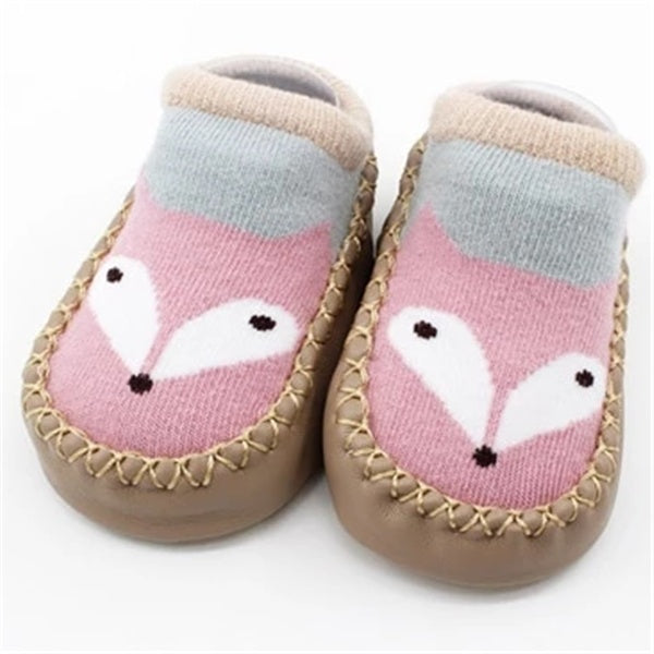 Pair of baby shoes with fox design on a white background