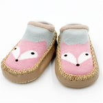 Pair of baby shoes with fox face design on a white background