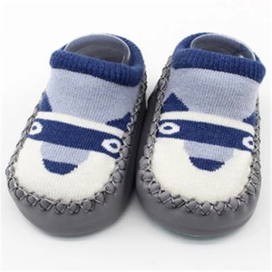 Pair of baby shoes with blue and white design on a white background