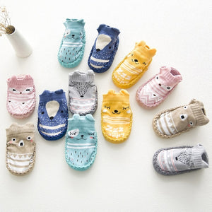 Collection of colorful baby socks with animal designs on a white background