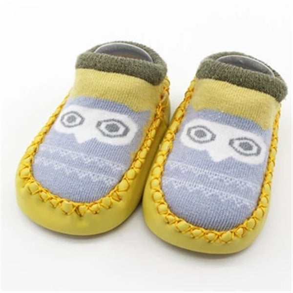 Pair of baby shoes with owl design on a white background