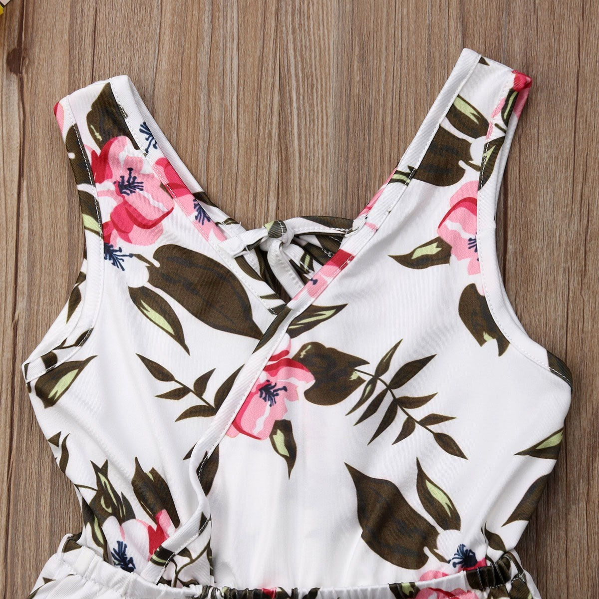 Floral-patterned swimsuit on a wooden surface