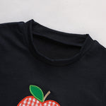 Black shirt with a red apple design on a white background