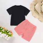 Black t-shirt and red checkered shorts with a straw hat on a light background