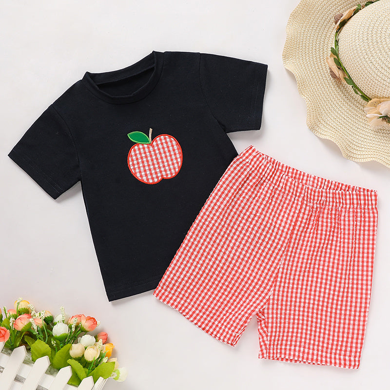 Black t-shirt with red checkered apple design and red checkered shorts on a white background.