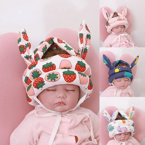 Collage of babies wearing colorful hats with animal ears on a pink background