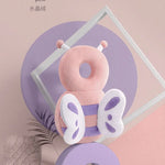 Pink butterfly-shaped product on a purple stand with a soft pink background
