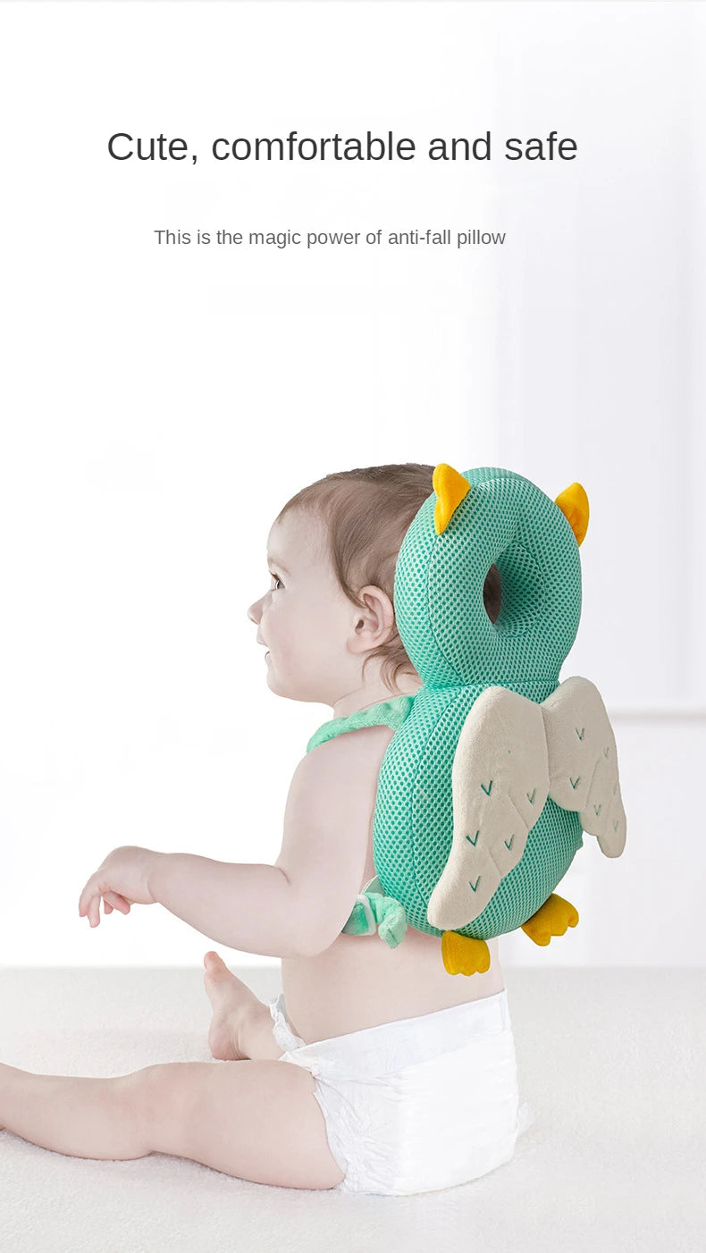 Baby wearing a green dinosaur-shaped anti-fall pillow on a white background