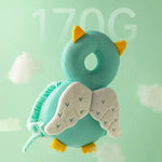 Teal owl plush toy with yellow accents on a light green background