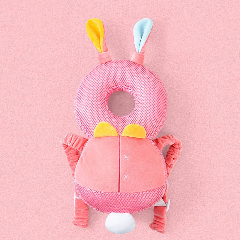 Pink baby head support with bunny ears on a pink background