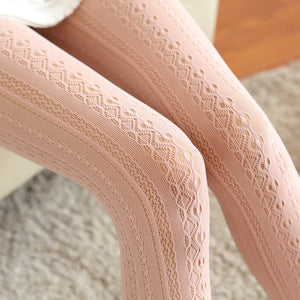 Close-up of beige lace tights on a blurred background