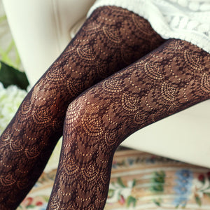 Brown lace tights on a floral-patterned surface