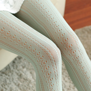 Close-up of light green lace tights on a chair.