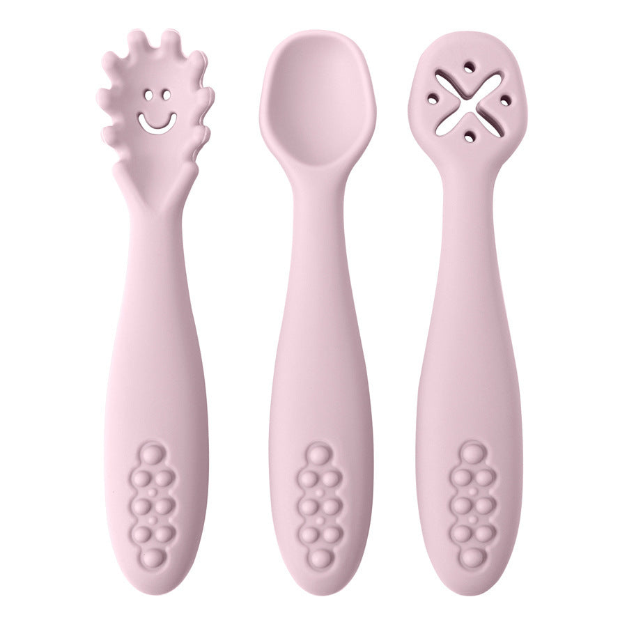 Set of three pink baby utensils with different designs on a white background