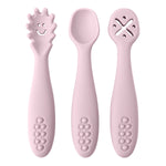 Set of three pink baby utensils with different designs on a white background
