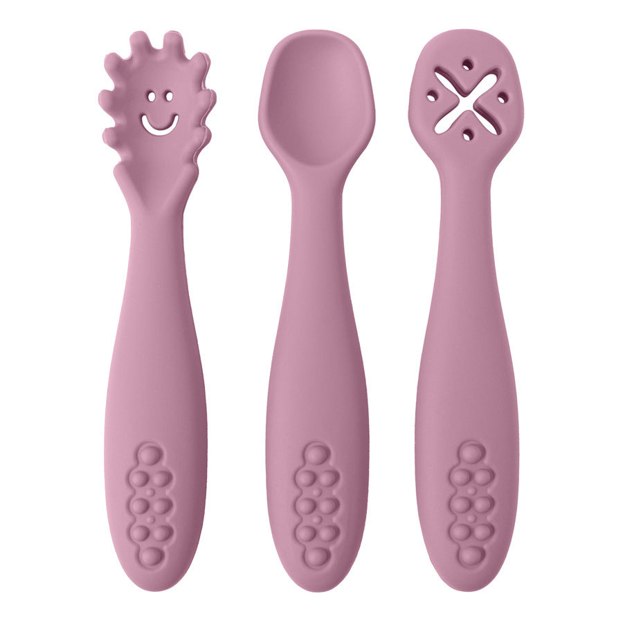 Three pink baby utensils with different designs on a white background