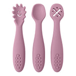 Three pink baby utensils with different designs on a white background