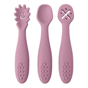 Three pink baby utensils with different designs on a white background