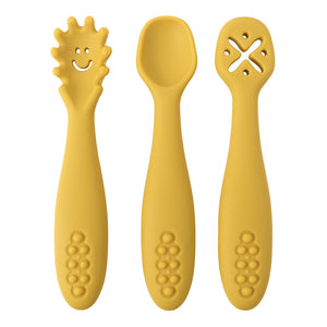 Three yellow baby utensils with unique designs on a white background