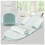Flax Green baby bouncer on a chair with a window in the background