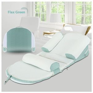 Flax Green baby bouncer on a chair with a window in the background