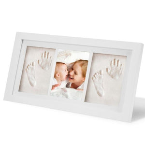 White photo frame with hand and footprints on a white background