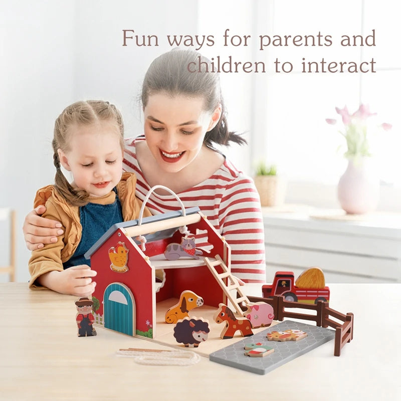 Woman and child playing with a toy farm set in a bright room.