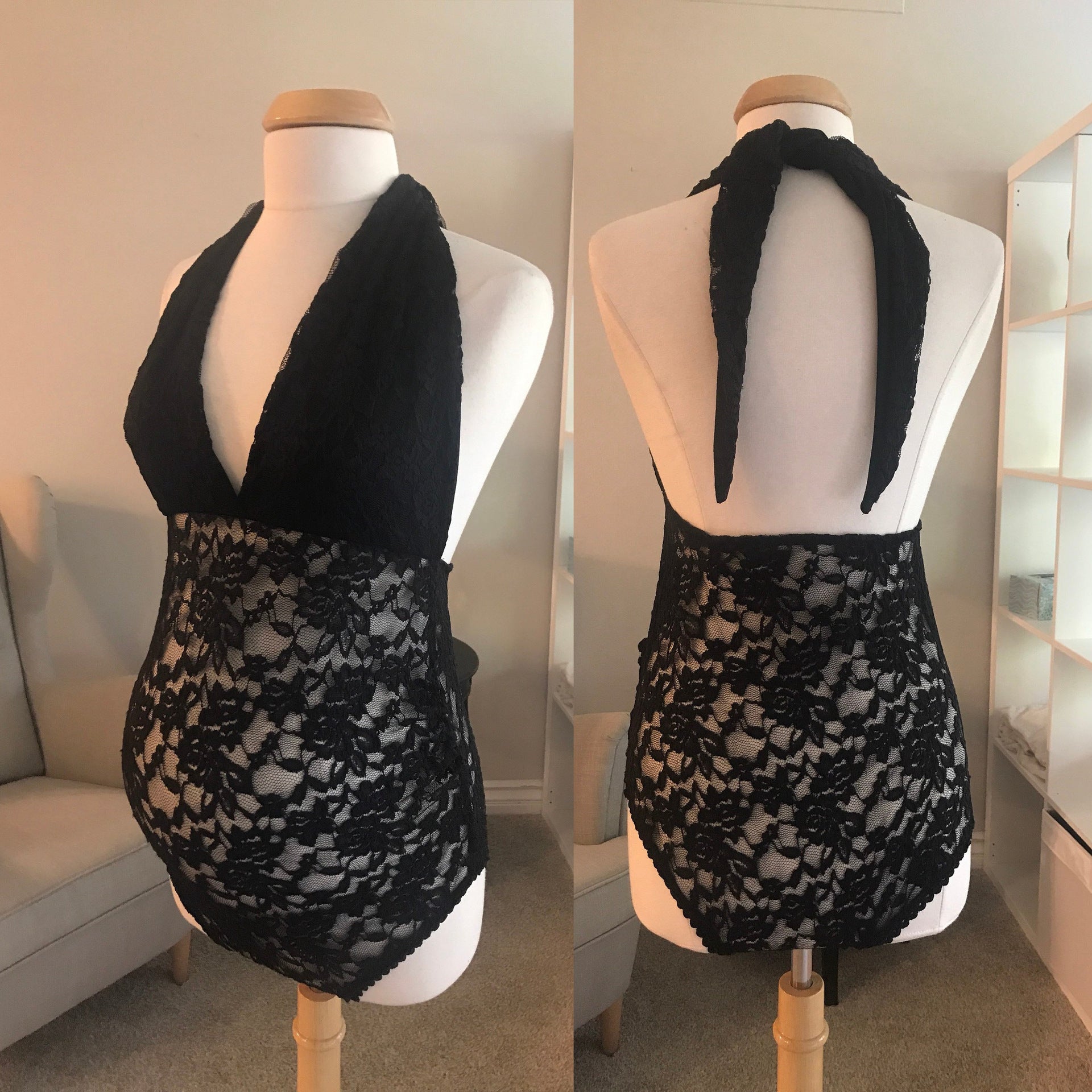 Black lace halter top on a mannequin against a neutral background