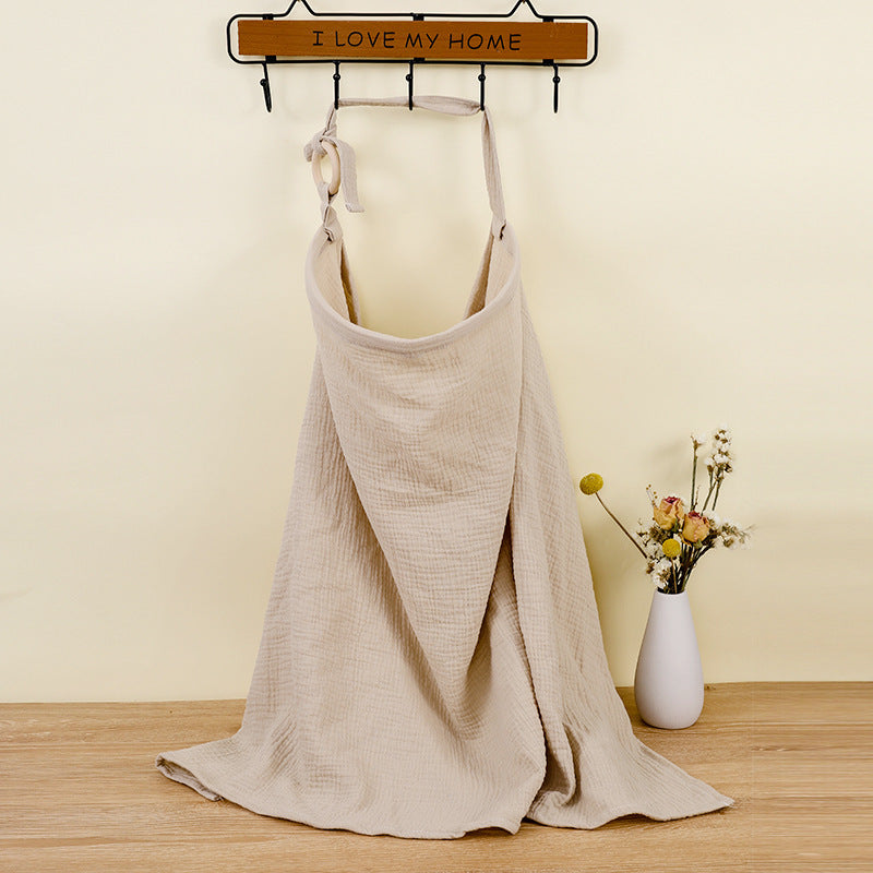 Beige apron on a mannequin with 'I LOVE MY HOME' sign in the background