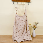 Beige dress with rainbow pattern on a mannequin against a yellow wall with a 'I LOVE MY HOME' sign.