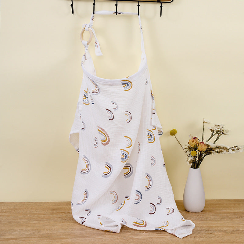 White dress with moon phase pattern hanging on a rack against a yellow wall.