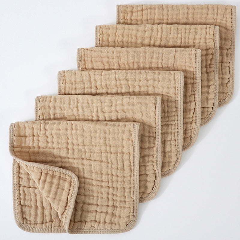 Set of beige quilted cloths on a white background