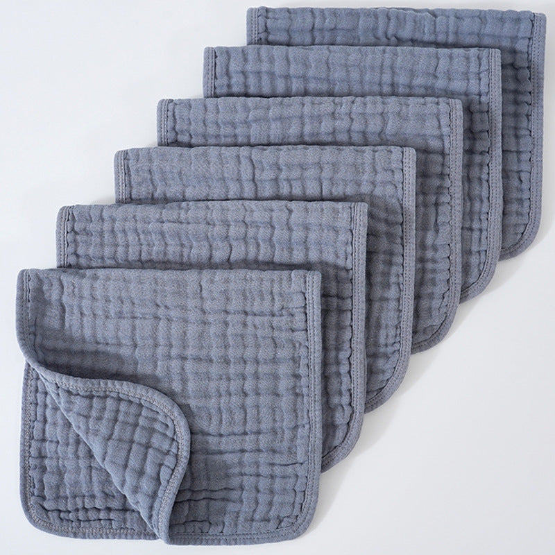 Set of gray textured cloths stacked on a white background