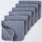 Set of gray textured cloths stacked on a white background