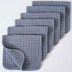 Set of gray textured cloths stacked on a white background