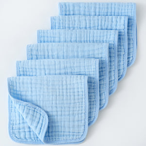 Set of light blue baby burp cloths on a white background