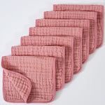 Set of pink textured cloths on a white background