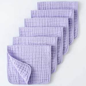Set of purple textured cloths on a white background