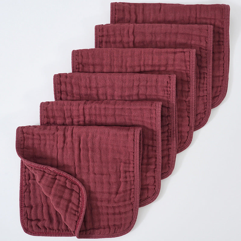 Set of red quilted baby blankets on a white background