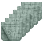 Set of six green textured cloths on a white background