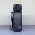 Black water bottle with a strap and logo on a light gray background