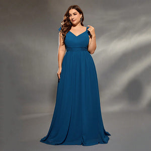 Woman wearing a blue dress against a gray left hand touching her solder