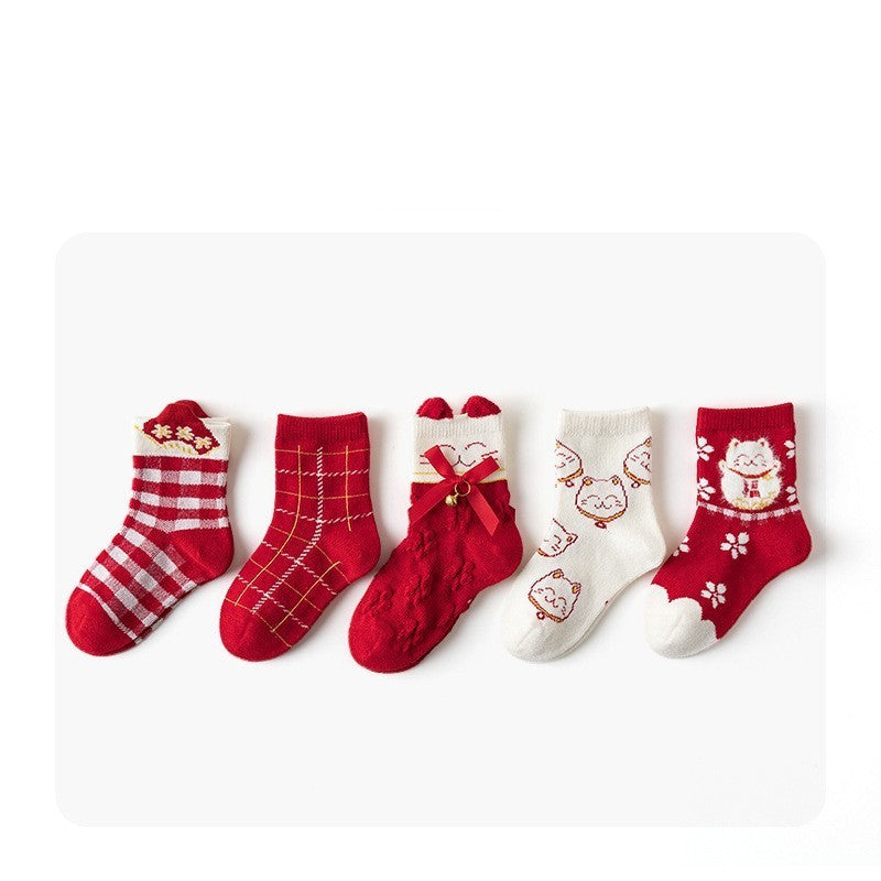 Set of red and white baby socks with various patterns on a white background