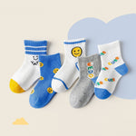 Set of colorful children's socks with various designs on a light background