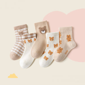Set of five baby socks with bear designs on a light background