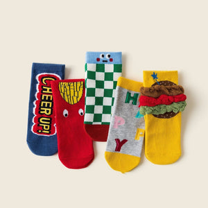 Five colorful socks with cartoon faces and designs on a beige background
