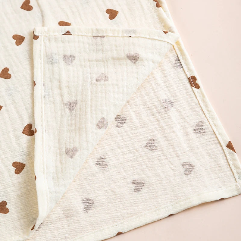 Beige fabric with brown heart patterns on a light pink background