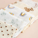Set of baby blankets with various patterns on a beige background