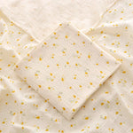 Quilt with yellow floral pattern on beige fabric