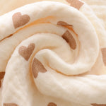 Close-up of beige fabric with brown heart patterns